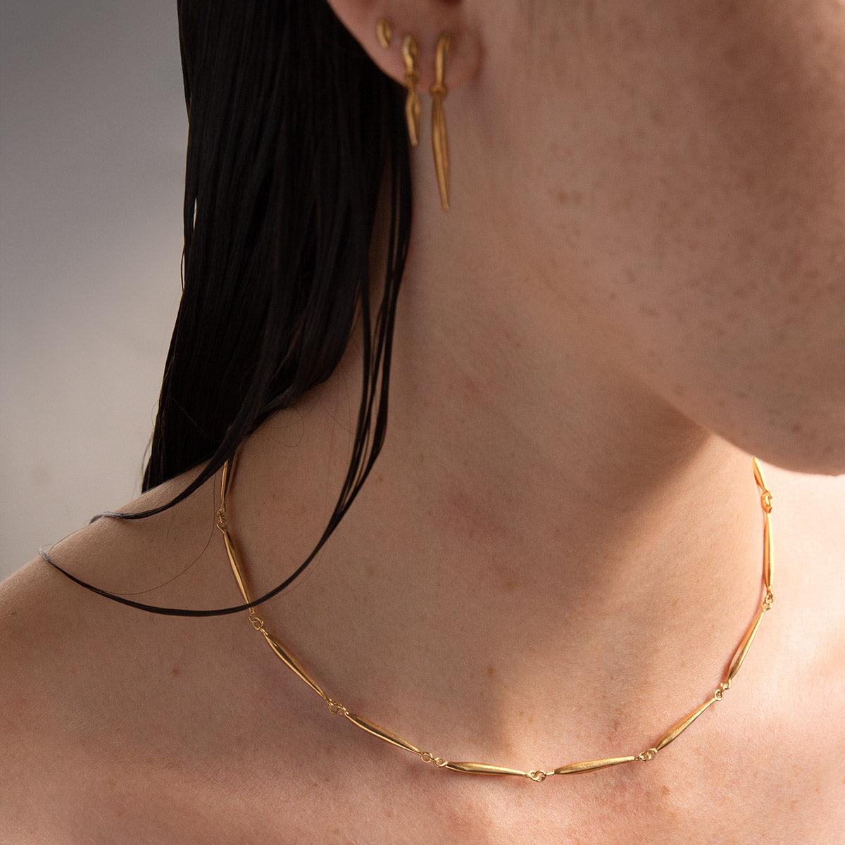 gold nexus necklace with elongated seed forms