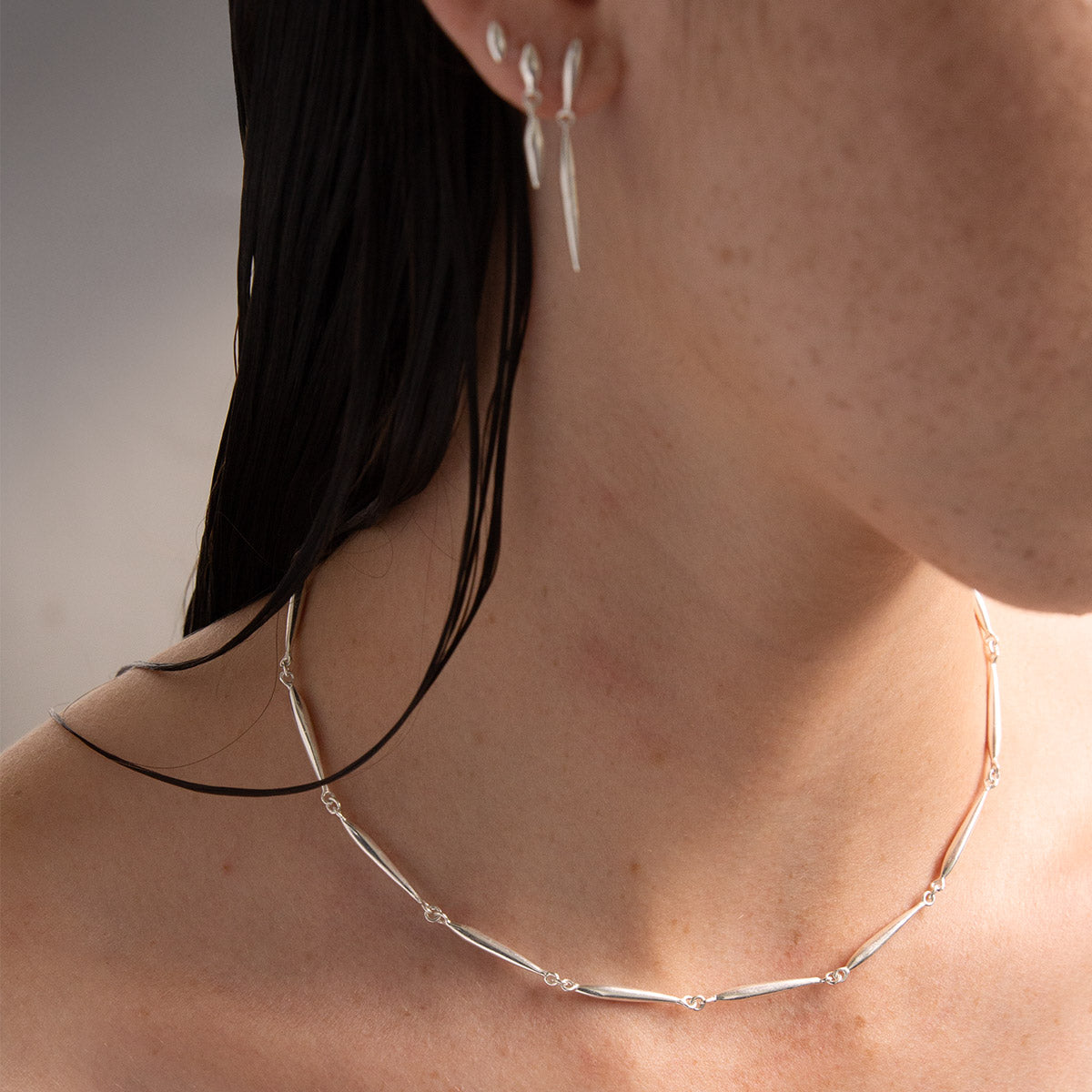 silver nexus chain necklace with elongated seed forms