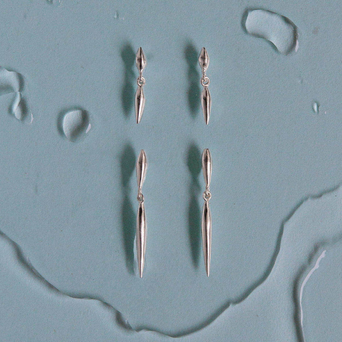 pair of silver nexus stud with elongated seed forms